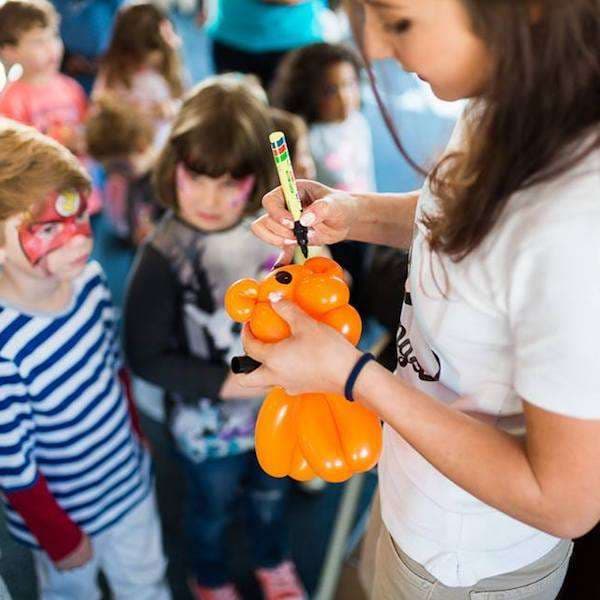 A bright, elaborate balloon art piece twisted for a kids party