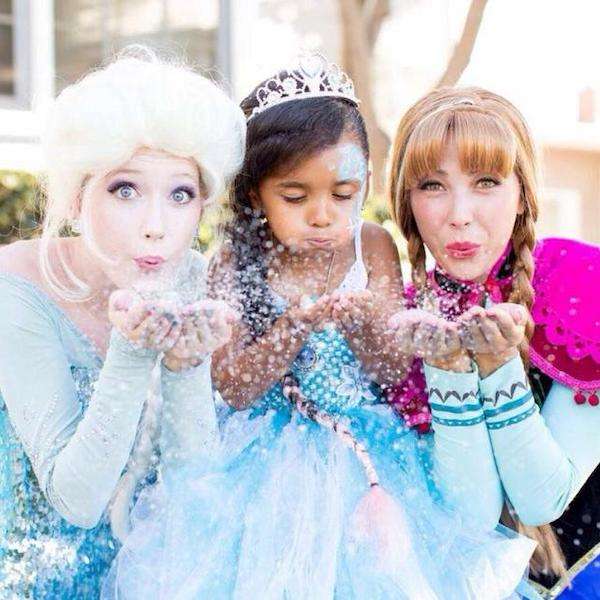 Costumed Frozen-inspired party characters celebrating with kids