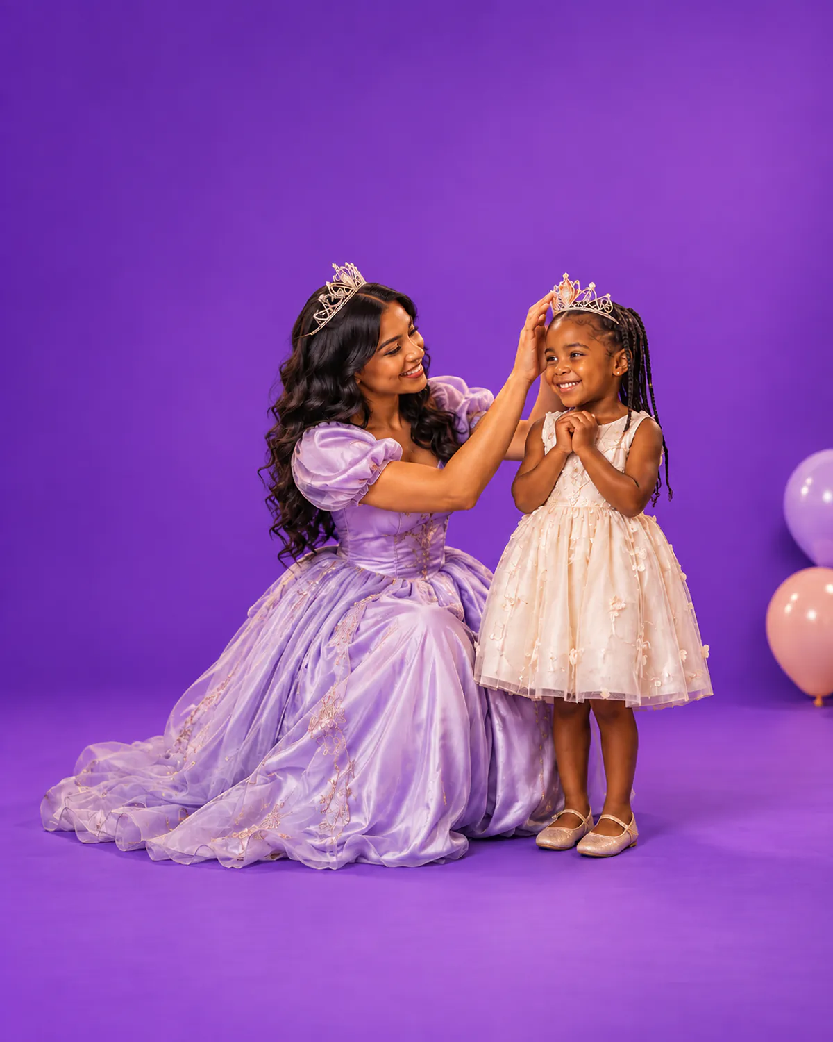 A princess character placing a tiara on a smiling birthday girl