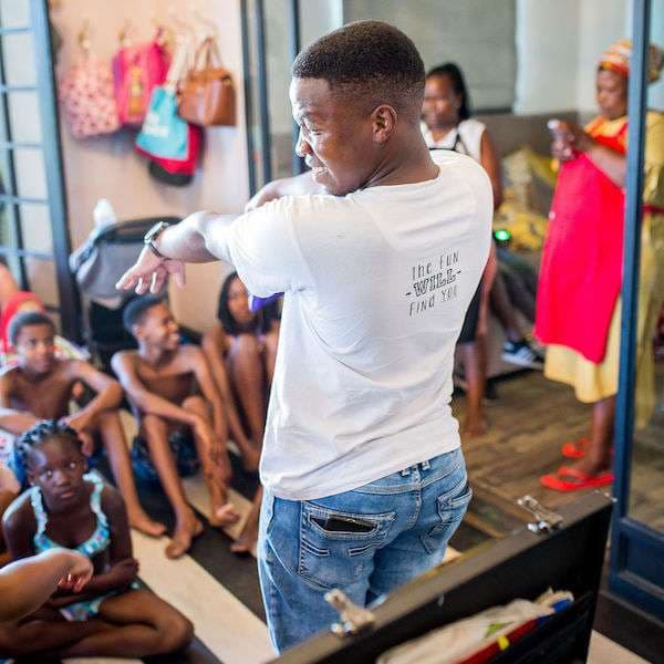 A magician entertaining kids with a card trick at a birthday party
